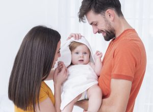baby-towel-held-by-parents
